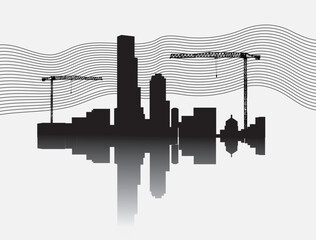 Silhouette of construction site with two crane towers