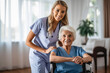 © MVProductions - Young nurse assisting a senior in a nursing home. Elderly patient care concept. Generative AI