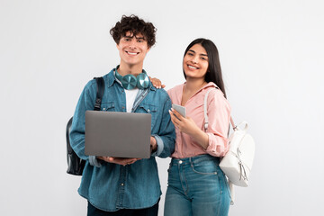 Students Couple Using Laptop And Smartphone Studying Over White Background