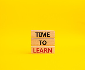 Time to learn symbol. Wooden blocks with words Time to learn. Beautiful yellow background. Business and Time to learn concept. Copy space.