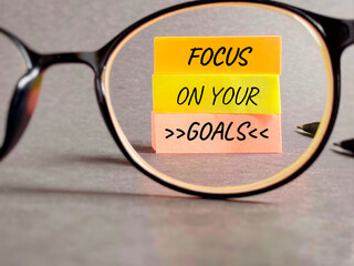 Wall Mural - Inspirational and motivational quote. Focus on your goals. Text written on notepaper background.