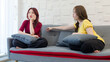 Asian young sad upset worried stressed depressed thoughtful angry female girlfriend sitting having problem thinking while lover couple trying to soothe comforting on cozy sofa in living room at home