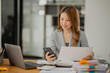 © aekachai - Asian business woman Working at the office, use notebook, smart phone