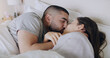 © Jordi/peopleimages.com - Couple, kiss and bedroom for love, care and romance of intimacy, special moment and quality time together at home. Man, woman and kissing partner for relationship, honeymoon and relax in the morning
