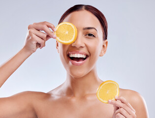 Wall Mural - Skincare, portrait or happy woman with orange or natural facial with citrus or vitamin c for wellness. Studio background, smile or healthy girl smiling with organic fruits for dermatology beauty