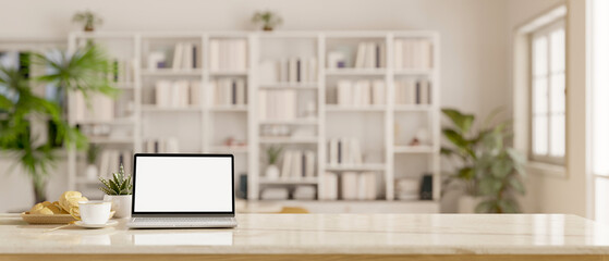 Wall Mural - Workspace with laptop mockup on a table in a white living room with large bookshelf.