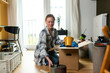 © Westend61 - Young woman unpacking containers from cardboard box