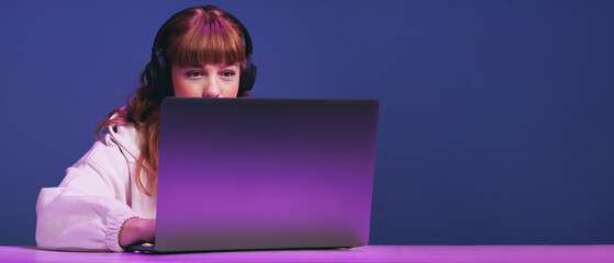 Young gamer playing an online video game in a studio