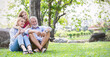 Portrait of happy family senior man woman and little girl relax in park. Mature elder family of three having fun together outdoor. Home school education, adopted child family lifestyle spring summer