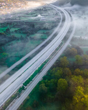 Aerial View Of Vehicles On The Highway Road At Sunrise With Low Clouds And Fog Among The Mountains In Psaka, Epirus, Greece.