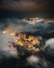 Aerial View Of Hong Kong Residential District At Night With Low Clouds, Kowloon, China.
