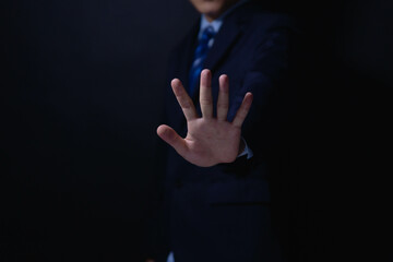 male hand showing stop gesture Concept of stop violence. Warning, prohibition, denial. On dark background.	
