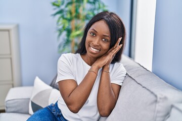 Wall Mural - Young african american woman smiling confident doing sleeping gesture with hands at home