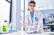 © Krakenimages.com - Young beautiful hispanic woman scientist writing report working at laboratory