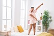 © Krakenimages.com - African american woman smiling confident dancing on bed at bedroom