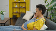 © Krakenimages.com - Young pregnant woman talking on smartphone with serious expression at home