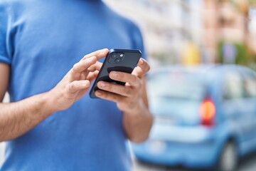 Sticker - Young latin man using smartphone at street