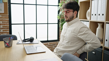 Poster - Young hispanic man business worker suffering for backache working at office