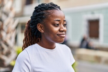 Wall Mural - African american woman smiling confident looking to the side at street