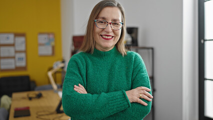 Sticker - Mature hispanic woman with grey hair smiling confident with crossed arms at office