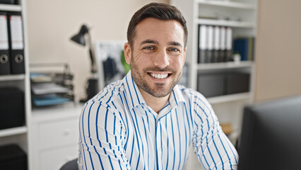 Canvas Print - Young hispanic man business worker using computer working at office