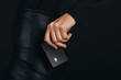 © Jacob Lund - Getting a hold on the pulse of modern banking: Female hand holds a premium bank card in a studio setting