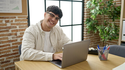 Sticker - Young hispanic man business worker using laptop working at office