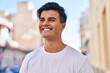 © Krakenimages.com - Young hispanic man smiling confident looking to the side at street