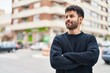 © Krakenimages.com - Young arab man smiling confident standing with arms crossed gesture at street
