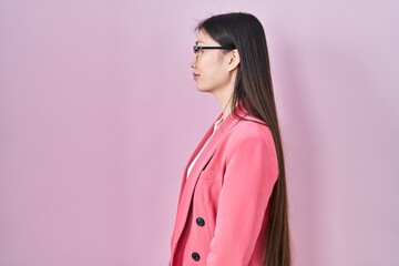 Wall Mural - Chinese business young woman wearing glasses looking to side, relax profile pose with natural face with confident smile.