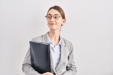 Canvas Print - Young caucasian woman wearing business clothes and glasses smiling looking to the side and staring away thinking.