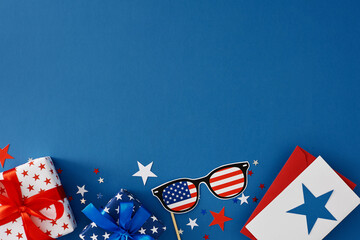 Wall Mural - Idea for a Fourth of July party. Top view flat lay of gift boxes, greeting card with star, patriotic paper glasses and star-shaped confetti on blue background with blank space for text or advert