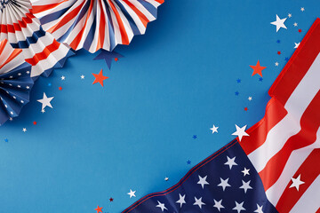 Wall Mural - 4th of July festivity concept. Top view flat lay of american flag, patriotic paper pinwheels, and blue, red, white stars on blue background with blank space for text or advert