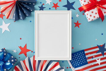 Idea for a Fourth of July celebration party. Top view flat lay of gift boxes, national flag, folding paper fans, star-shaped confetti on light blue background with empty frame for text or advert