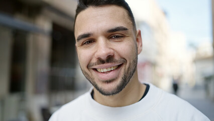 Canvas Print - Young hispanic man smiling confident standing at street