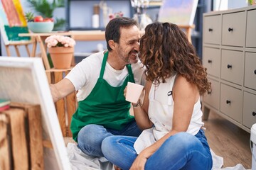 Wall Mural - Man and woman artists drinking coffee drawing at art studio