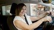 © Krakenimages.com - Middle age hispanic woman smiling confident driving car at street