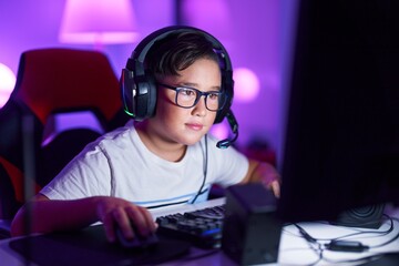 Sticker - Adorable hispanic boy streamer playing video game using computer at gaming room