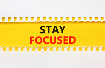 Stay focused symbol. Concept words Stay focused on beautiful yellow paper on beautiful white background. Business, support, motivation, psychological and stay focused concept. Copy space.