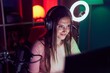 © Krakenimages.com - Young beautiful hispanic woman streamer playing video game using computer at gaming room