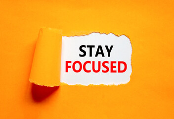 Stay focused symbol. Concept words Stay focused on beautiful white paper on a beautiful orange background. Business, support, motivation, psychological and stay focused concept. Copy space.