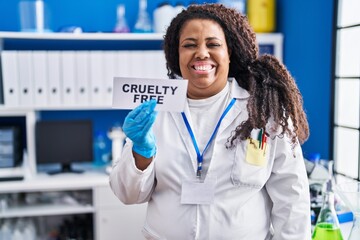 Sticker - Plus size hispanic woman working on cruelty free laboratory looking positive and happy standing and smiling with a confident smile showing teeth