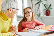 © Lumos sp - grandchild grandmother family granddaughter child teacher homework creativity home woman book notebook grandma education classroom grandparent parent daughter girl kid teaching