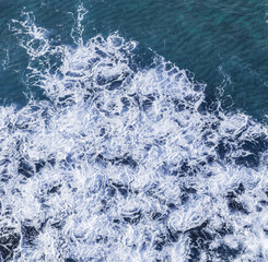 Wall Mural - ocean foamy pattern on water surface. top view.