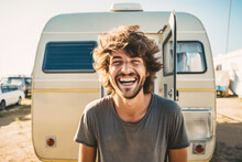 Generative AI Illustration Of Cheerful Young Man With Wavy Hair Smiling And Looking At Camera While Standing Against Camper Van During Road Trip
