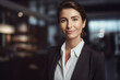 © ADDICTIVE STOCK - AI generated image of smiling brunette businesswoman waist up in the hotel lobby, wearing black jacket and looking at camera