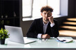 © F8  \ Suport Ukraine - Businessman sitting at office desk working on laptop