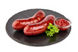 German grilled pork sausages with tomato sauce, close-up, isolated on white background.