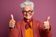 © ink drop - Studio portrait of a happy senior woman with thumbs up positive hand gesture. Generative ai