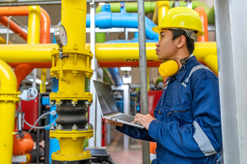 Wall Mural - Maintenance technician at a heating plant,Petrochemical workers supervise the operation of gas and oil pipelines in the factory,Engineers put hearing protector At room with many pipes